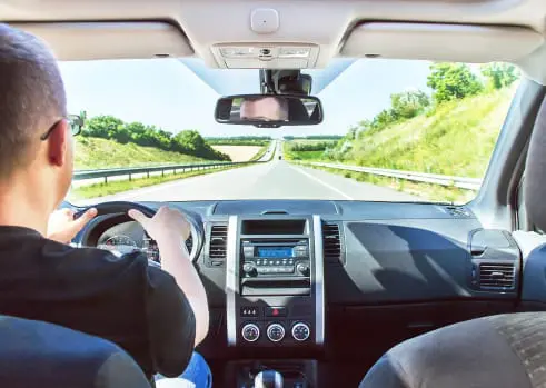 Carolina Collision and Frame Service | Interior shot of a man driving down a highway