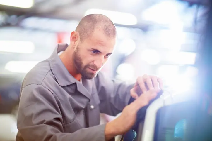 Carolina Collision and Frame Service | Auto Repair Technician inspecting a repair on a car in an auto body shop