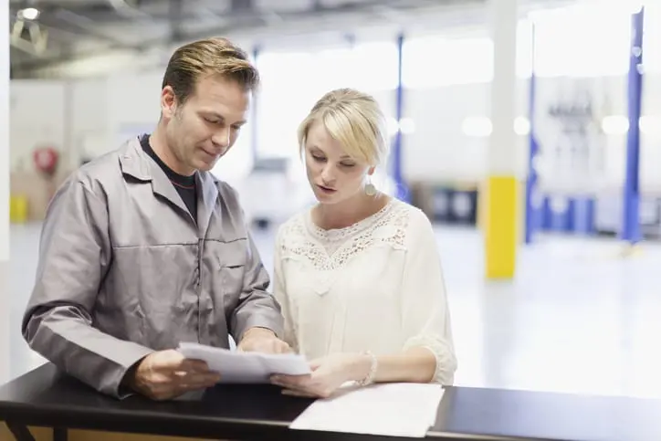 Carolina Collision and Frame Service | Customer and mechanic going over paperwork at an auto repair shop